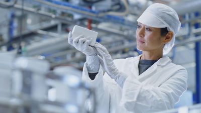 Female operator examining carton package
