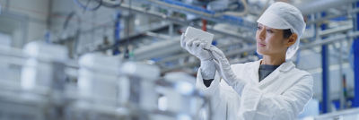 Female operator examining carton package