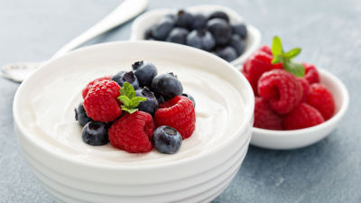 Fermented yoghurt in a bowl with blueberries and raspberries