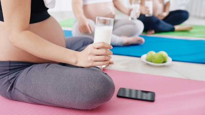Pregnant woman holding glass of milk