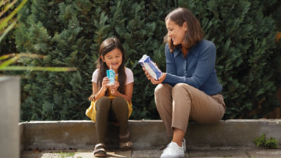 Woman and child drinking from cartons