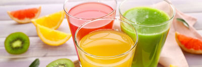 red orange and green juice with fruits around