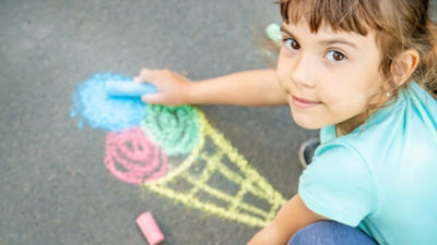 Girl with crayons, drawing ice cream
