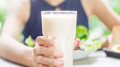 Girl holding a glass of milk
