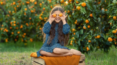 Girl holding oranges