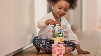 Girl playing with Tetra Recart packages