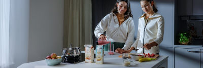 Healthy breakfast, girls in the kitchen, Tetra Rex cartons on the table