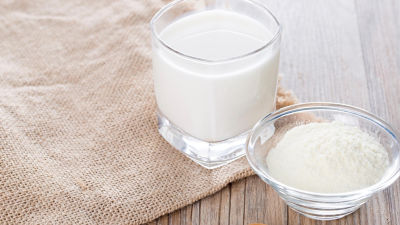 Milk in glass and milk powder
