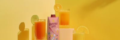 Glasses with juice and a carton package