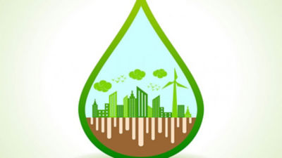 Una gota verde con un dibujo de una ciudad en el interior