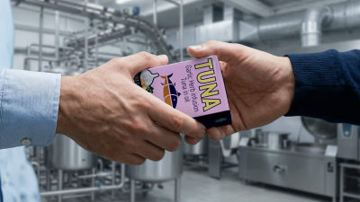 Hands holding Tetra Recart carton with tuna