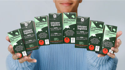 hands holding eight tetra recart carton packages