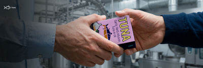 Hands holding Tetra Recart carton with tuna