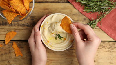 Hummus in bowl, dipping tortilla chips