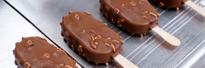 Chocolate-coated ice cream bars on industrial production line