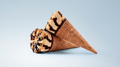 Decorated waffle cone filled with ice cream and chocolate topping