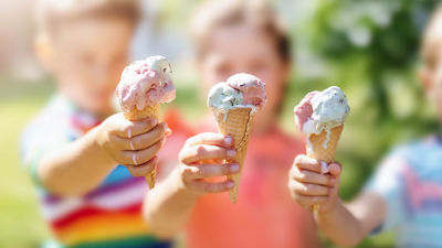 3 kids holding out their ice cream cones