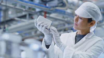 Female packaging specialist Inspecting carton