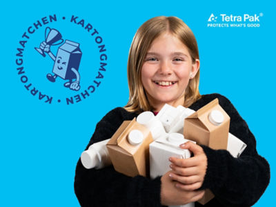 Flicka med dryckeskartonger