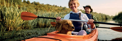 two people kayaking with dog