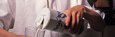 Boy pouring milk from carton