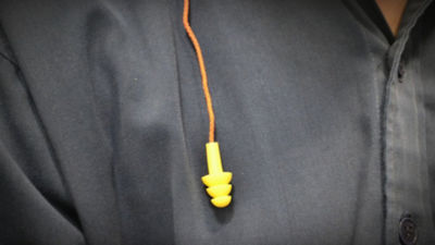 Man wearing yellow earplug
