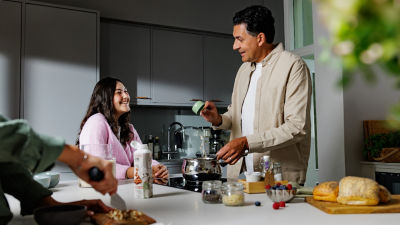 Man and woman in kitchen, Tetra Top carton on the table