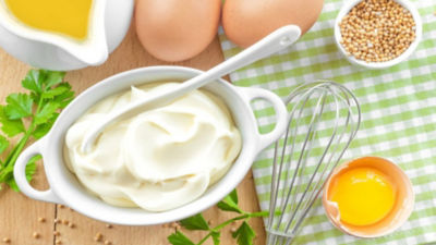 A bowl of mayonnaise on a table