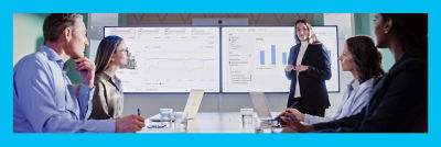 People in meeting, data on large screens