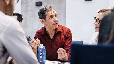 Man with carton in a meeting
