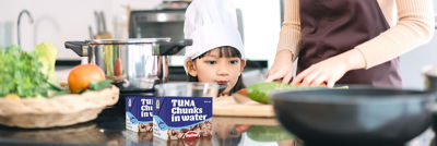 Mini chef helping out in the kitchen, tuna in Tetra Recart carton packages