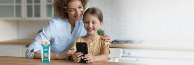 Mother and child with smartphone, connected package