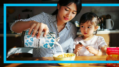 Mother and girl, milk in Tetra Brik Aseptic carton package