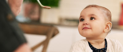 Baby being fed with baby food