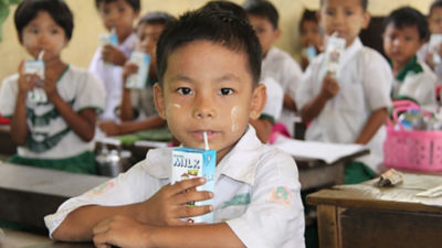 Myanmar boy drinking milk