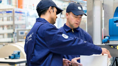 Operators with cardboard box, distribution equipment