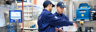 Operators with cardboard box, distribution equipment