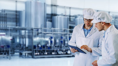 Operators with tablet, processing plant