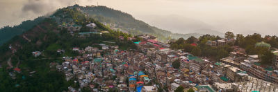 Aerial top view of Muree village, Islamabad with residential local houses and fog mist, nature trees, Pakistan in urban city town in Asia,