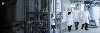 People at production site, equipment in background