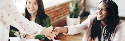 People in meeting shaking hands