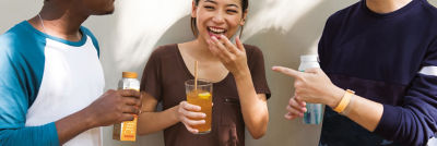 Happy people, carton packages and juice in glass