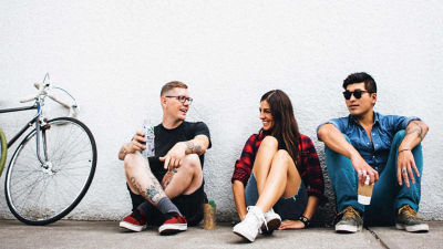 People sitting leaning against wall
