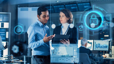 Man and woman in control room, digital icons around them 