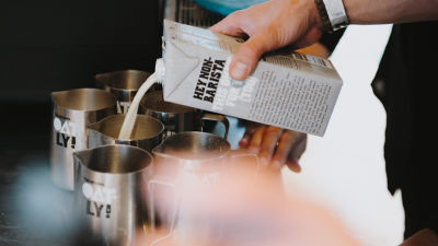 Pouring oat milk in jug, Tetra Brik Aseptic carton