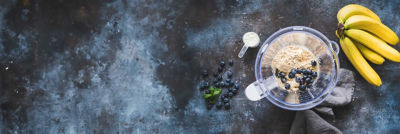 top view of powder and fruit in a blender