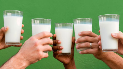 Group of people holding glasses of milk