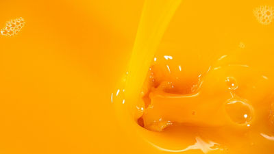 Close-up of orange juice with splashing liquid texture