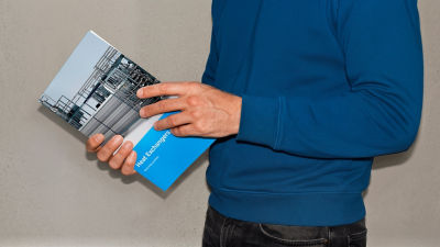 Person holding heat exchanger processing brochure