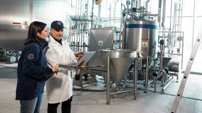 Workers inspecting industrial processing tank